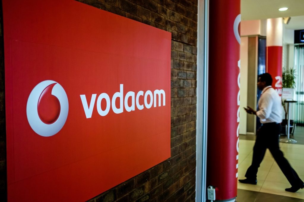 Vodacom logo on brick wall in office lobby.