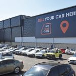 Cars parked outside vehicle sales building - WeBuyCars