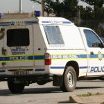 South African Police Service vehicle responding to a violent crime scene