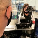 US border control officers processing travelers at an international airport using biometric screening technology