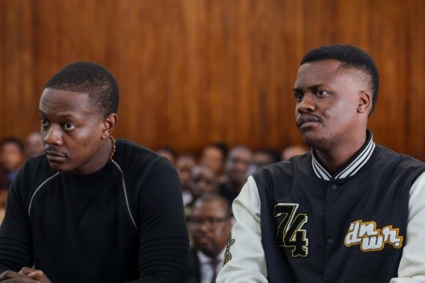 Two men seated in courtroom during hearing
