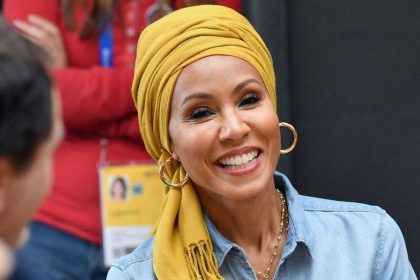 Smiling woman wearing yellow headscarf and hoop earrings