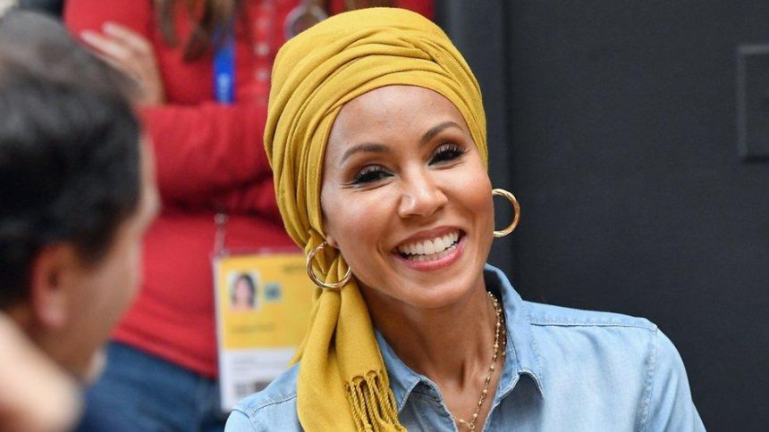 Smiling woman wearing yellow headscarf and hoop earrings