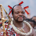 Man in traditional Zulu attire holding spear
