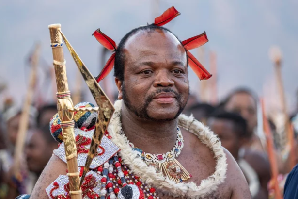 Man in traditional Zulu attire holding spear