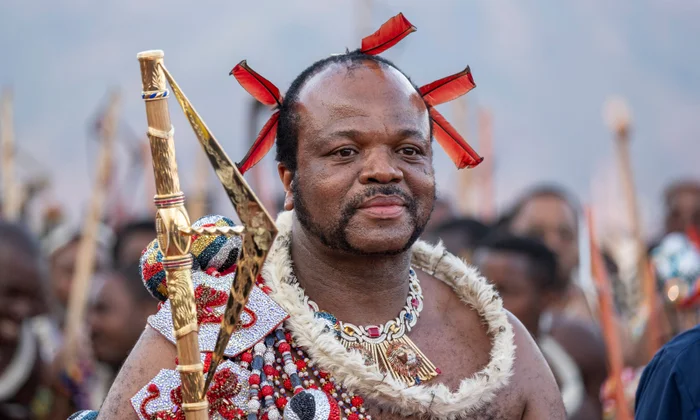 Man in traditional Zulu attire holding spear