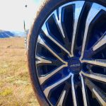 Close-up of muddy car wheel in countryside