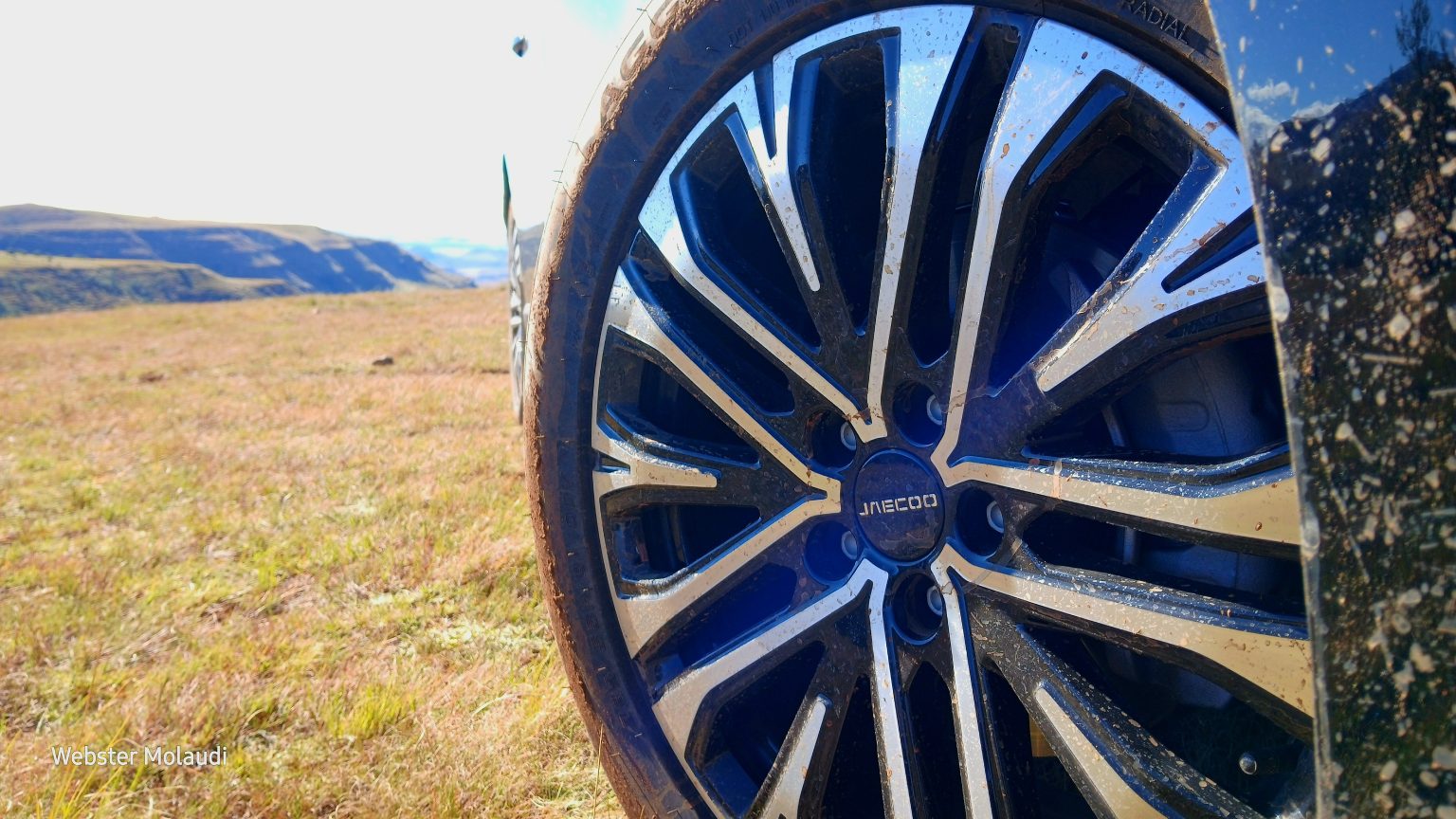 Close-up of muddy car wheel in countryside