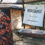 Man in traditional blanket beside Bothobapelo banner