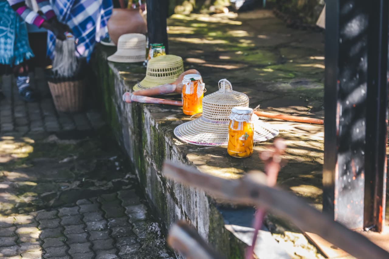 Jars of preserves and straw hats outdoors