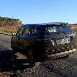 Black SUV parked on rural country road