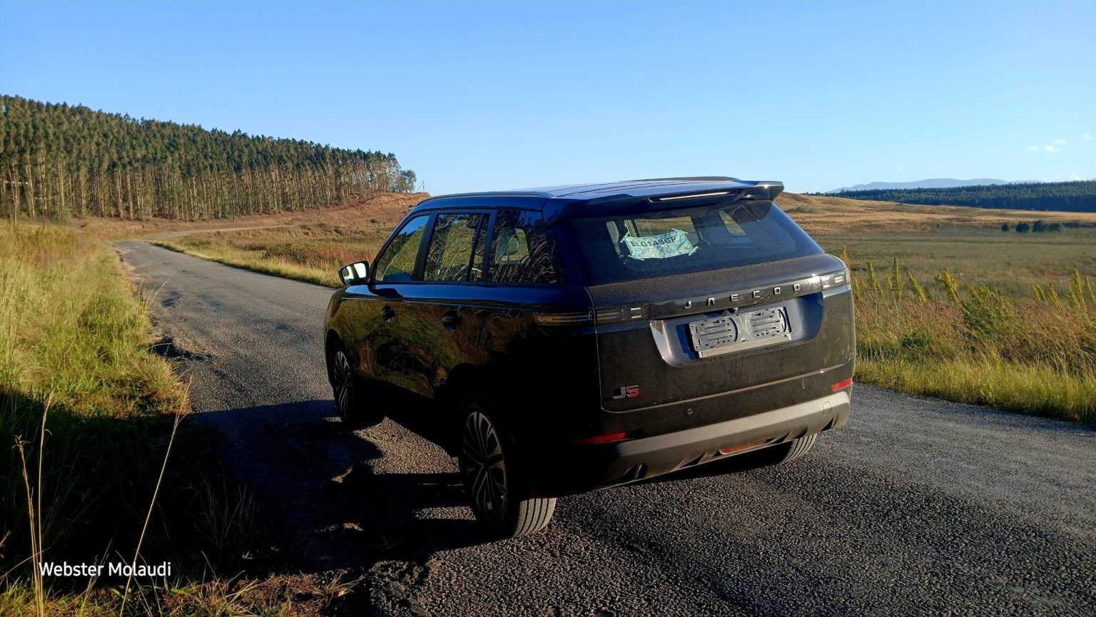 Black SUV parked on rural country road