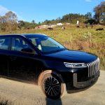 Black SUV parked on rural dirt road