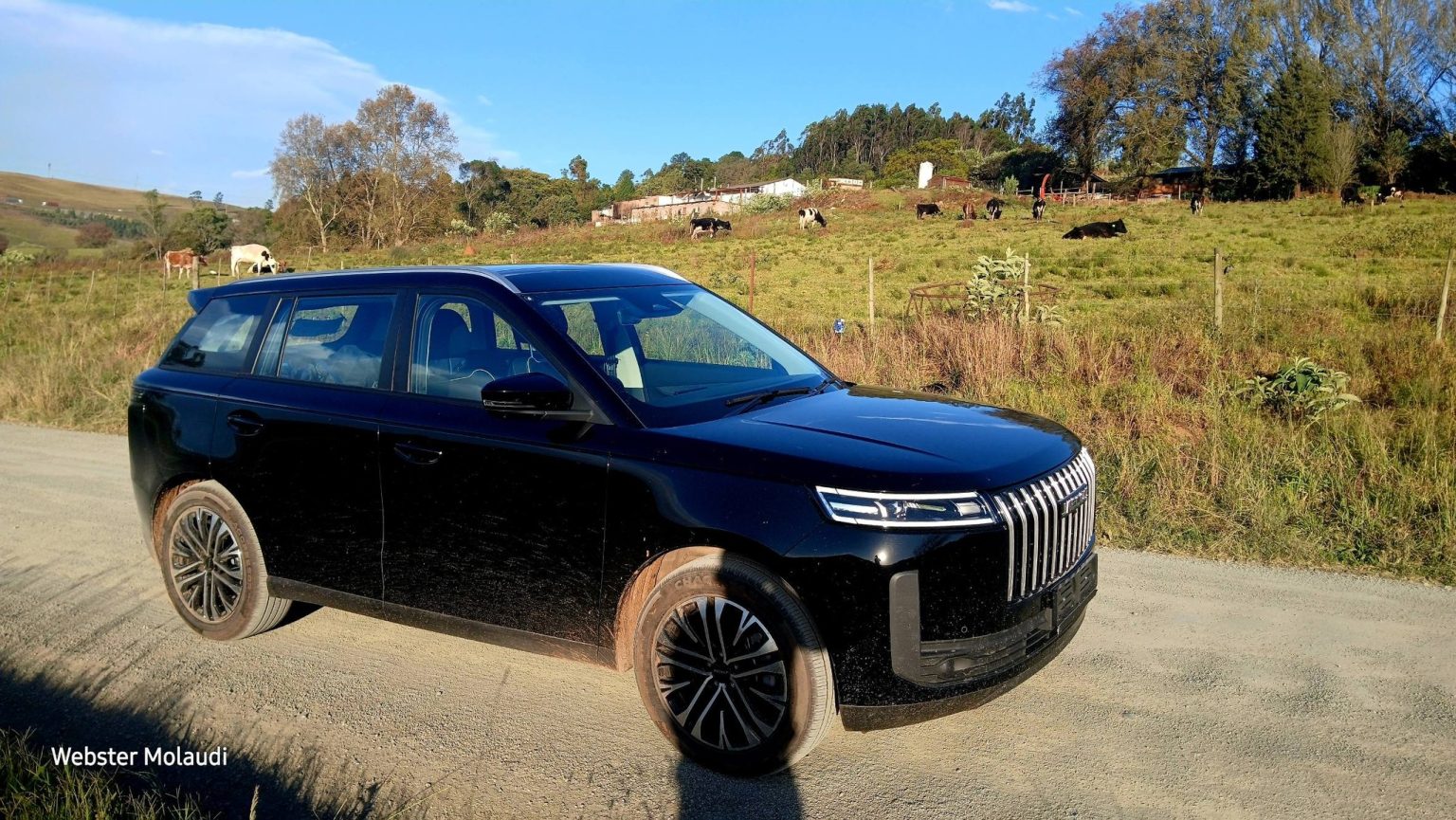 Black SUV parked on rural dirt road