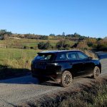 Black SUV parked on rural gravel road