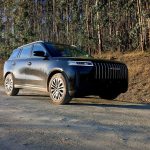 Black Jaecoo SUV on gravel forest road