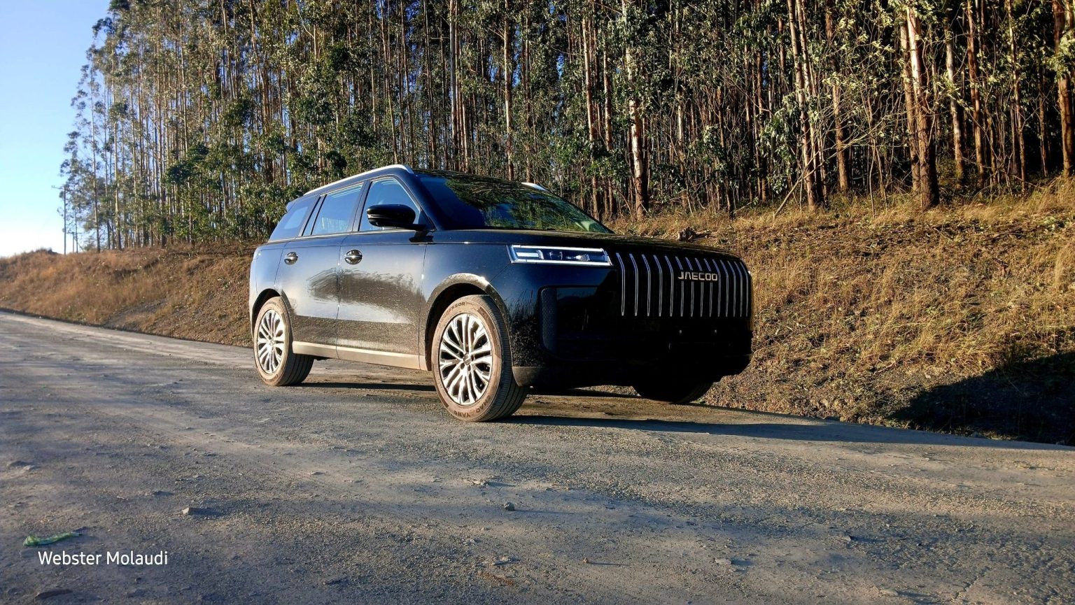 Black Jaecoo SUV on gravel forest road