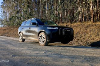 Black Jaecoo SUV on gravel forest road