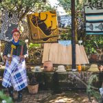 Woman at traditional craft stall with blankets