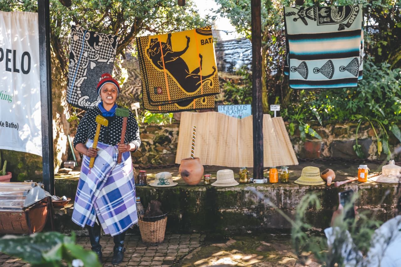 Woman at traditional craft stall with blankets