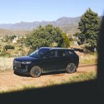 Black SUV on rural dirt road
