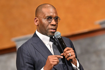 Man in suit speaking into microphone
