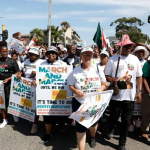 Protesters marching with placards in city street