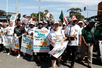 Protesters marching with placards in city street