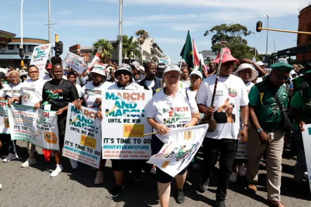 Protesters marching with placards in city street
