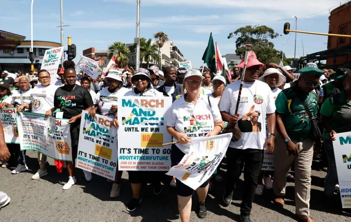 Protesters marching with placards in city street
