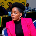 Woman in pink blazer at conference meeting