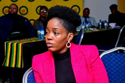 Woman in pink blazer at conference meeting