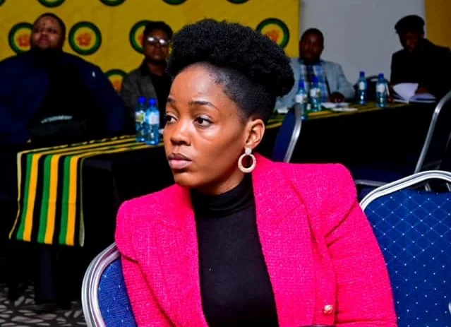 Woman in pink blazer at conference meeting