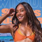 Woman in orange bikini at tropical beach