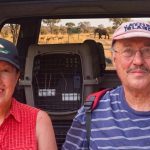 Couple on safari with elephants in background
