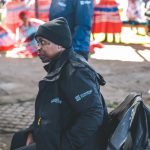 Woman in black jacket at outdoor cultural event