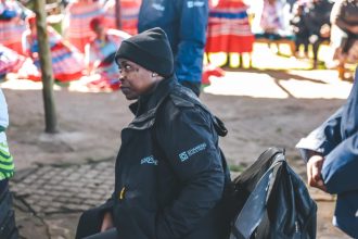 Woman in black jacket at outdoor cultural event