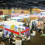 Busy indoor tourism trade show exhibition hall