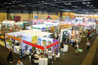 Busy indoor tourism trade show exhibition hall