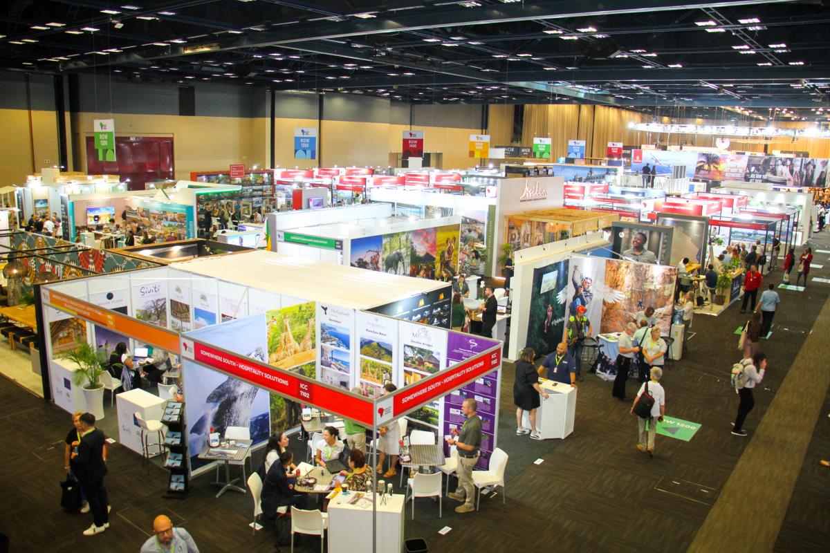Busy indoor tourism trade show exhibition hall