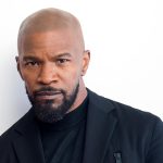 Bald man in black blazer and turtleneck