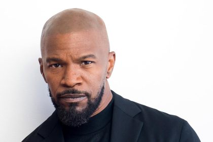 Bald man in black blazer and turtleneck