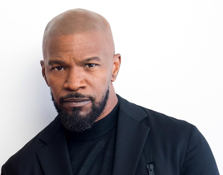 Bald man in black blazer and turtleneck