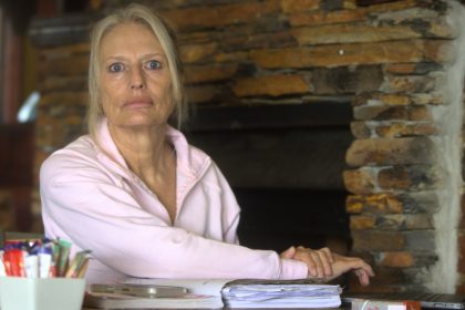 Older woman sitting at desk with papers