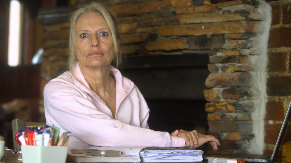 Older woman sitting at desk with papers