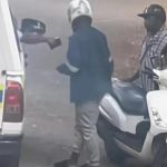 Police officer speaking to scooter rider roadside