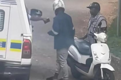 Police officer speaking to scooter rider roadside