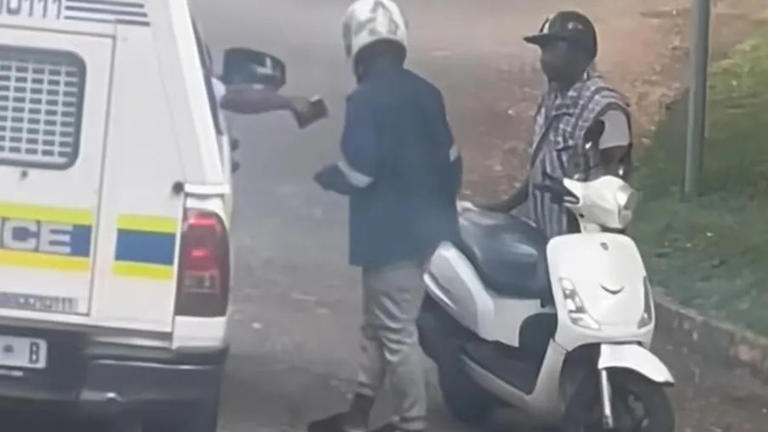 Police officer speaking to scooter rider roadside
