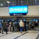 Passengers queuing at Terminal A airport check-in