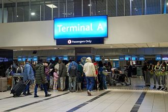 Passengers queuing at Terminal A airport check-in